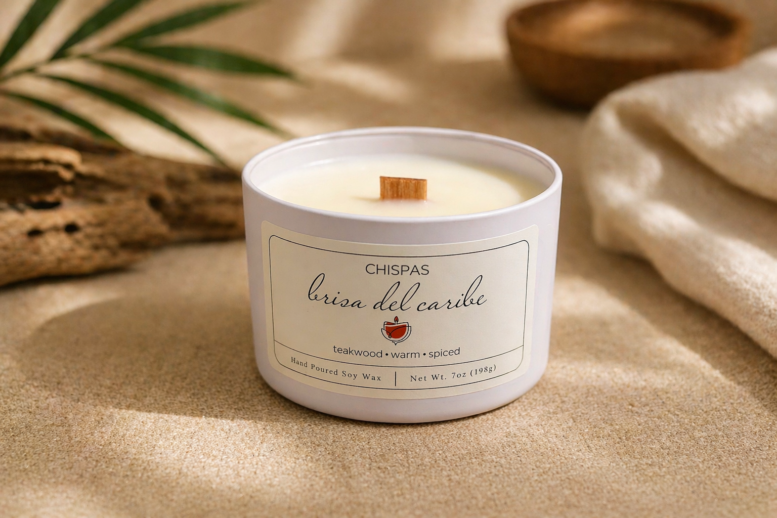 Close-up of Brisa del Caribe candle by Chispas showing the wooden wick and smooth coconut soy wax in a minimal neutral setting.