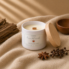 Hand-poured Brisa del Caribe candle by Chispas with a wooden wick and lid beside it, styled with warm spiced elements on a soft fabric surface.